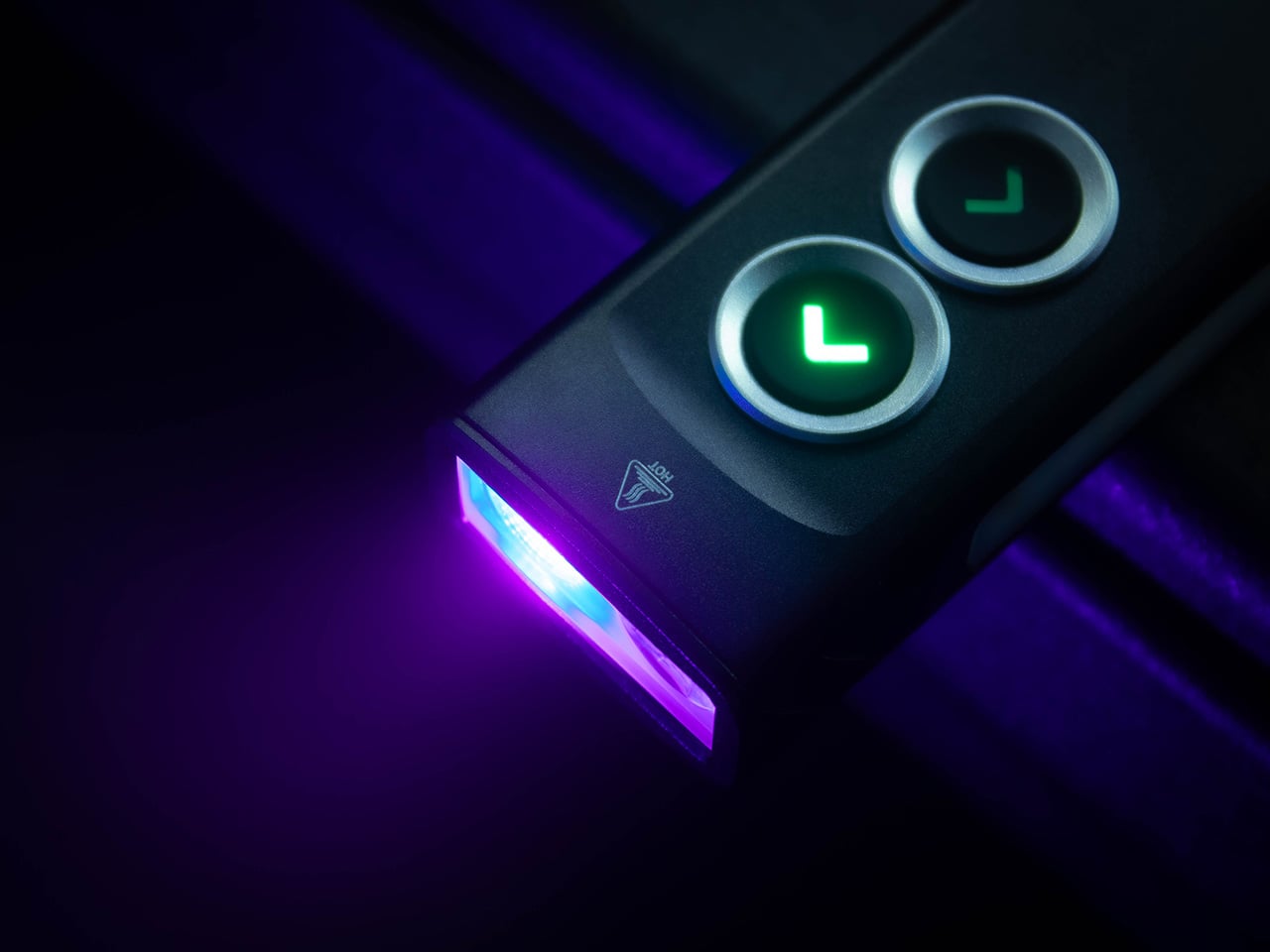 Elevator control panel with two circular floor buttons showing glowing green 'L' indicators; purple light shines from below.