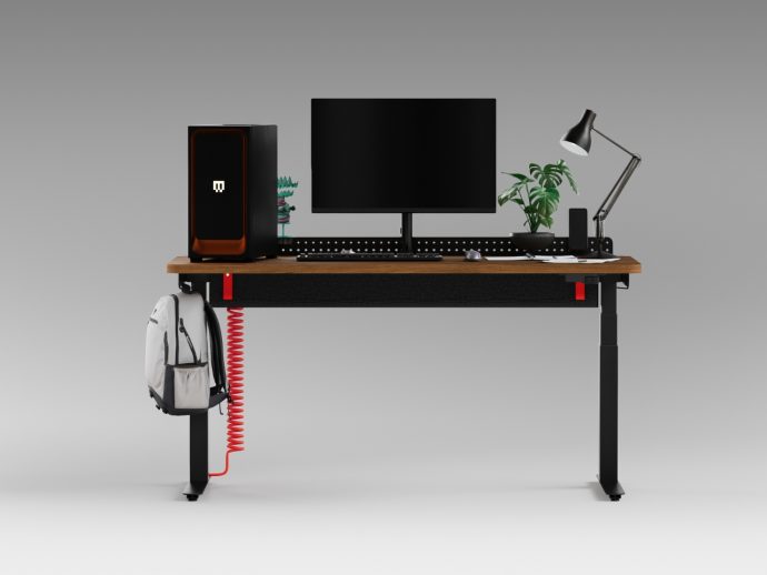Desk setup: monitor and keyboard on wood desk, left computer tower, desk lamp, plant, and a backpack hanging from a red coiled cord under the desk.