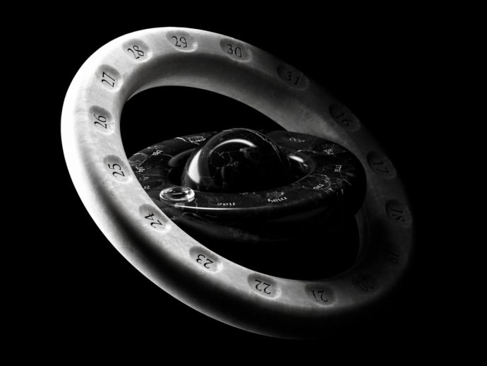 Abstract 3D sculpture: a white numbered ring looping around a glossy black inner core against a black background (artistic, geometric form).