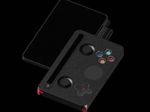 Black handheld game console with a slide-out tray, two thumbsticks, a circular touchpad, and four colored action buttons.