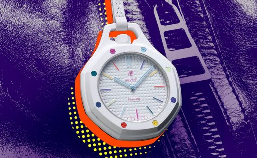 White two-tone wristwatch with colorful hour markers and a textured dial, set against a purple leather background.