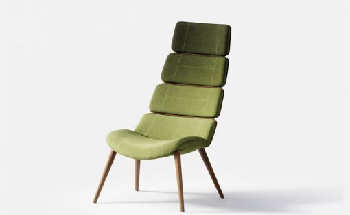 Green upholstered lounge chair with a tall, segmented backrest and four wooden legs.