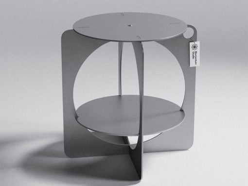 Modern metal sculpture resembling a circular, two-tier stand with curved panels and a tag reading 'Moment Museum Studio'