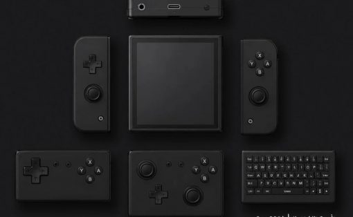 Dark modular gaming console with a square central screen surrounded by handheld controllers and a compact top module; minimalist, monochrome setup.