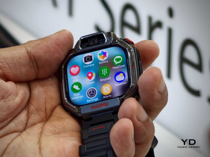 Huawei smartwatch held in a hand, showing a colorful app grid on the screen (Camera, Gallery, Maps, Weather, Settings, Alarm) with a black metal band.