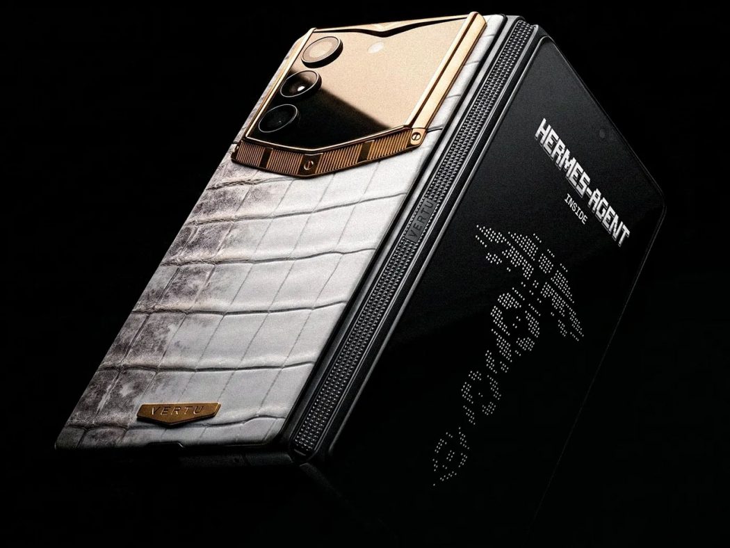 Luxurious Vertu smartphone with white crocodile leather back and gold camera module, Hermes edition, against a dark backgroundie.