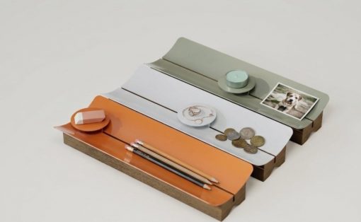 Multi-tier wooden desk organizer with orange, white, and green shelves holding pencils, eraser, coins, rings, and a small photo.