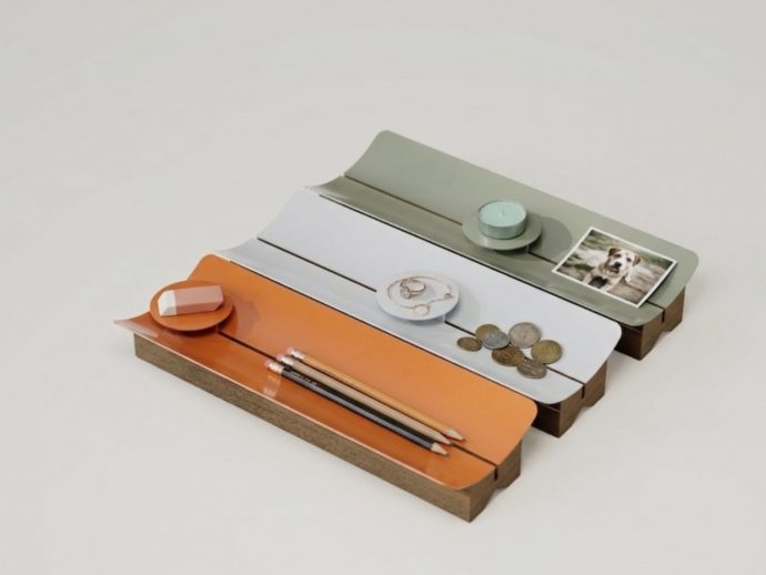 Multi-tier wooden desk organizer with orange, white, and green shelves holding pencils, eraser, coins, rings, and a small photo.