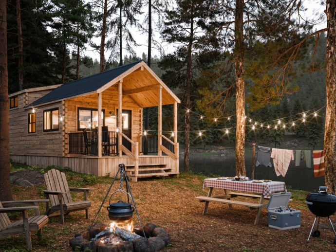 This 400-Square-Foot Log Cabin Has a Loft, a Covered Porch, and Cathedral Ceilings — and It Arrives on a Flatbed