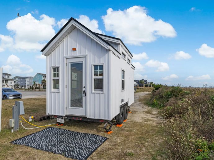 This Tiny Home Packs a Full-Size Fridge, Loft Bedroom, & Sleeping for Four Into 128 Square Feet