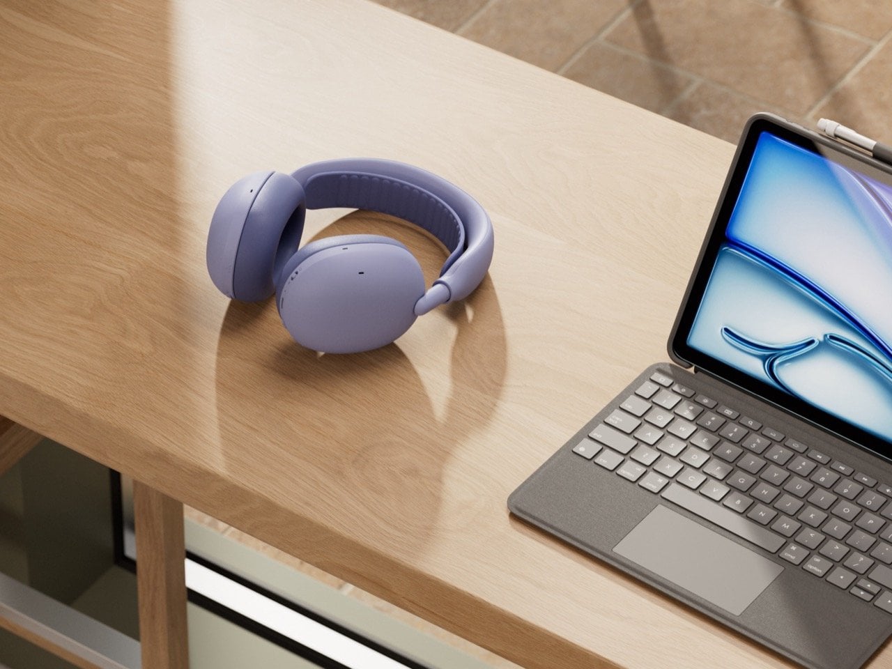 Lilac Logitech Zone Vibe Pro headphones on a wooden desk next to a tablet keyboard