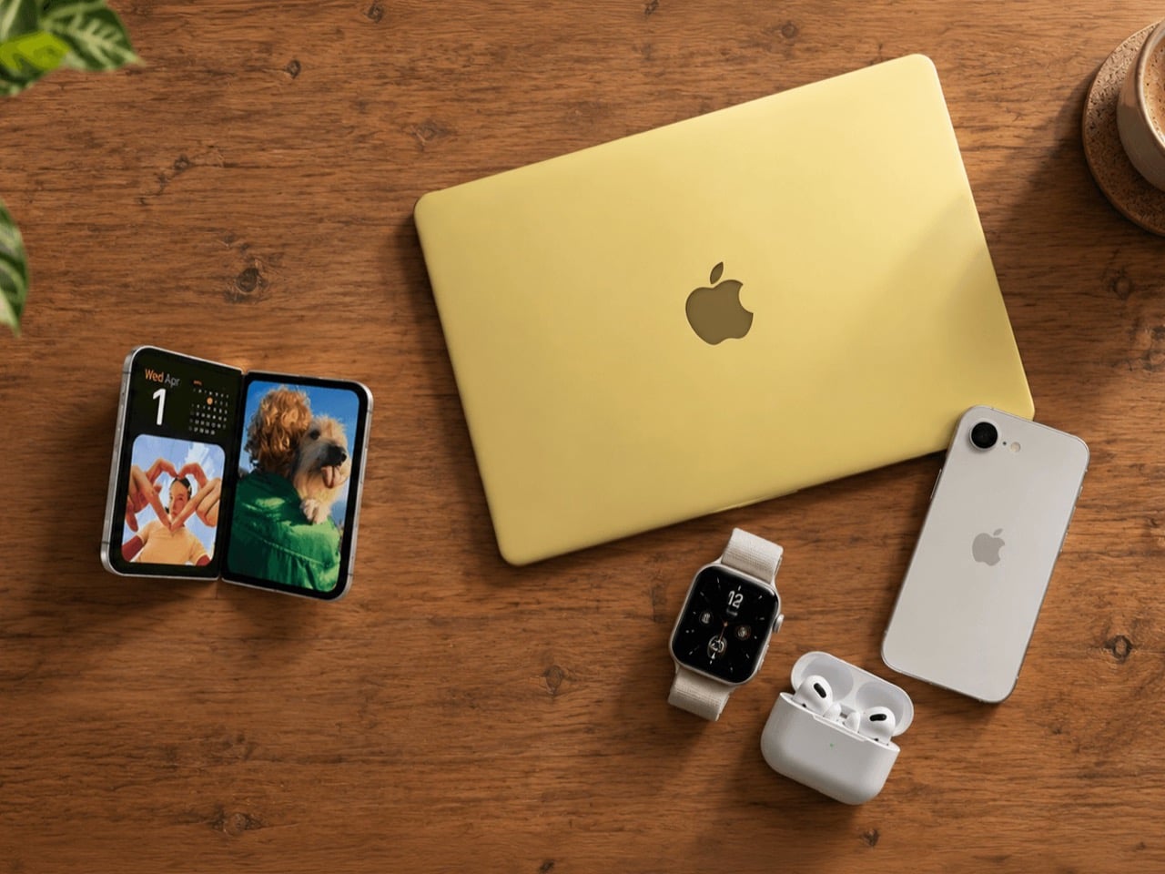 The iPhone Duo, MacBook Neo, iPhone 17e, Watch SE3, and AirPods Pro 3 placed on a wooden table.
